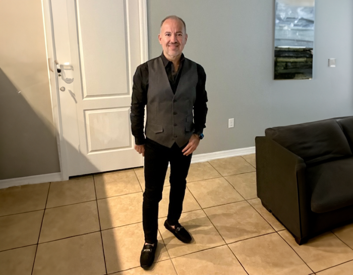 A man standing in front of a living room.