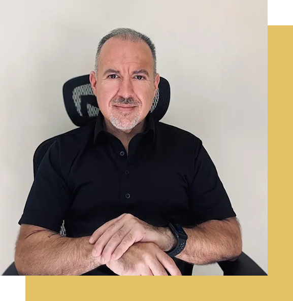 A man sitting in a chair wearing a black shirt.